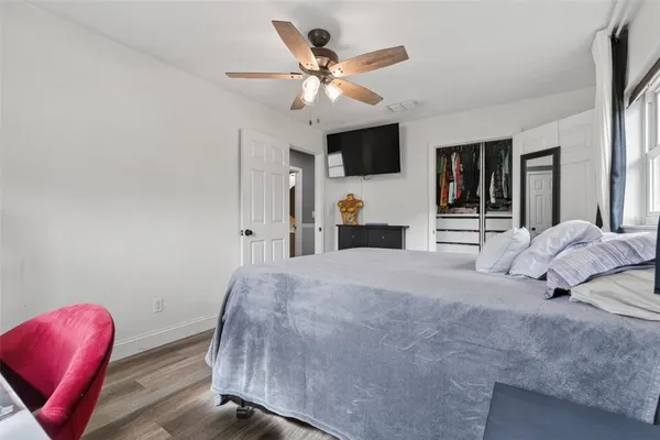 a bedroom with a large bed and a flat screen tv
