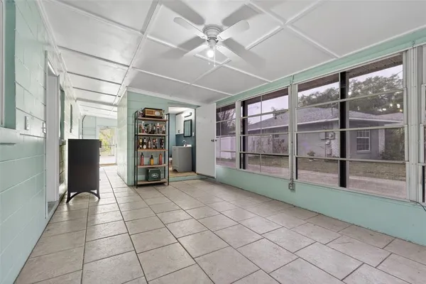 a view of an empty room with window and cabinet
