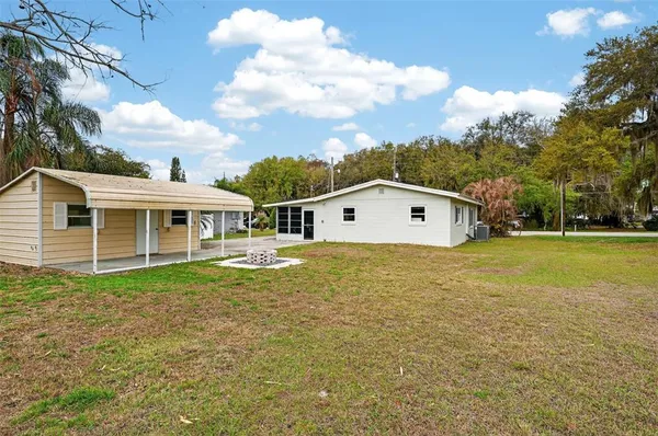a front view of house with yard and trees