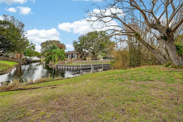 a view of a house with yard and lake view