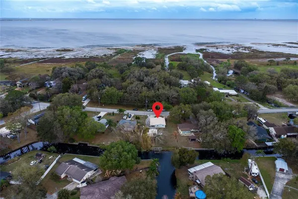an aerial view of a houses with a yard