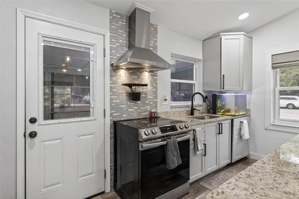 a kitchen with stainless steel appliances granite countertop a stove and a sink