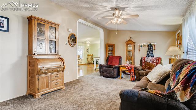 17570 Sage Crest Road Peyton, CO 80831 - Photo 6 of 25 Living room opens to great room inclusive of family room, dining, and kitchen