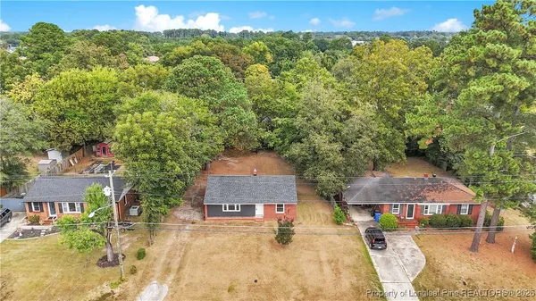 an aerial view of a house with a yard