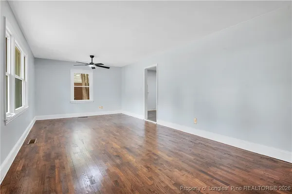 wooden floor in an empty room with a window