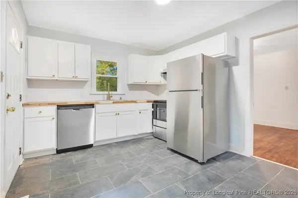 a kitchen with a stove a refrigerator and a sink