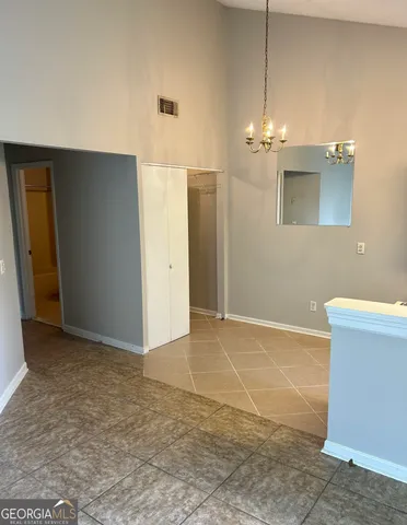 a view of a livingroom with a chandelier fan