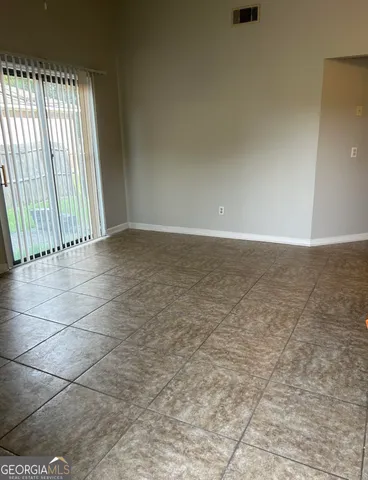 a view of an empty room and window