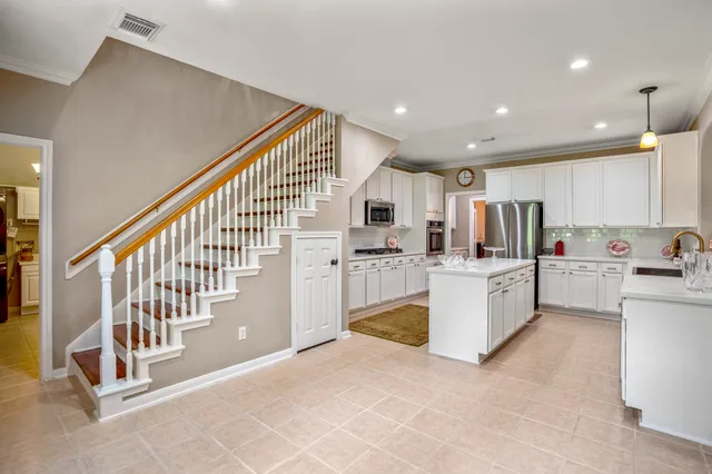 a large white kitchen with a large window