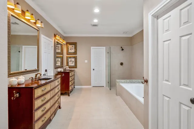 a spacious bedroom with a large bed and wooden floor