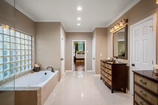 a spacious bedroom with a bed and a walk in closet