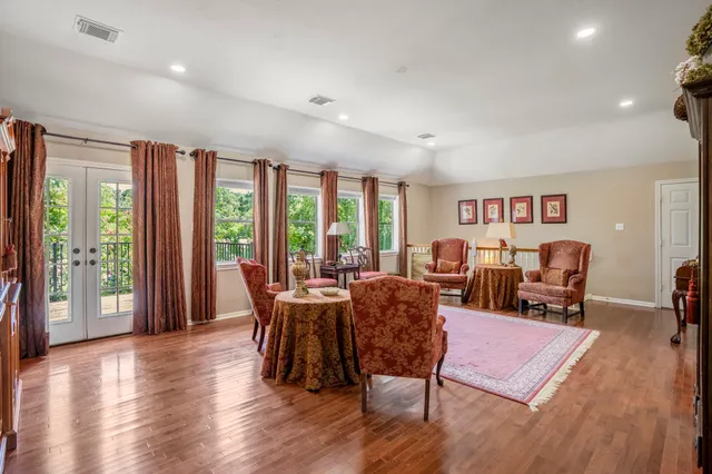 a bathroom with a tub a shower and a window