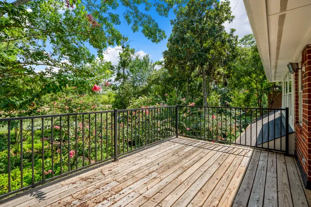 a bathroom with a granite countertop sink a mirror a vanity and a shower