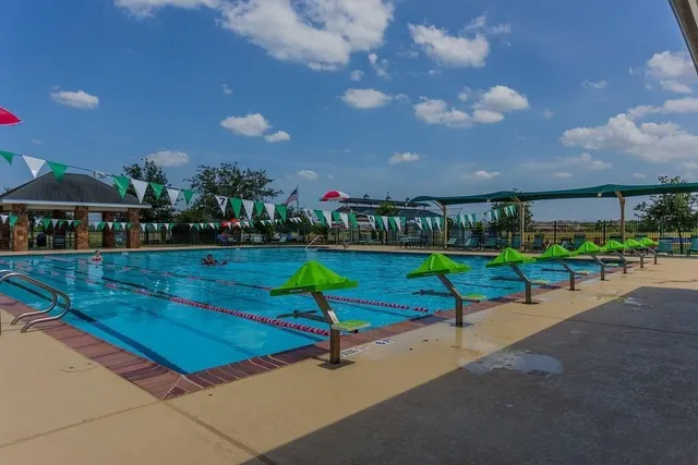 an aerial view of lake residential house with outdoor space and trees around