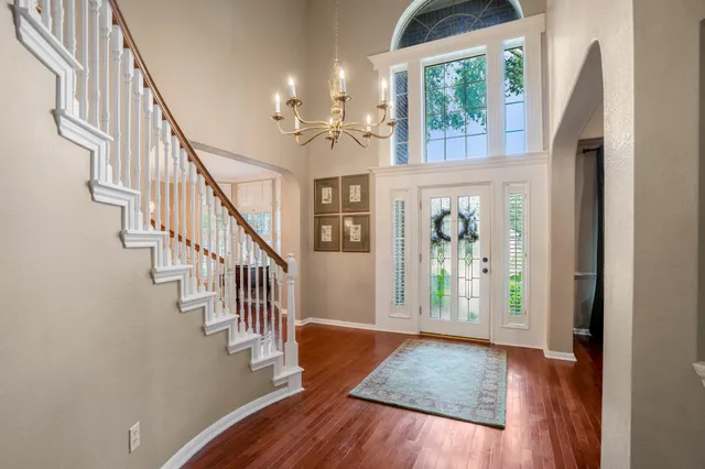 a view of an entryway with wooden floor and front door