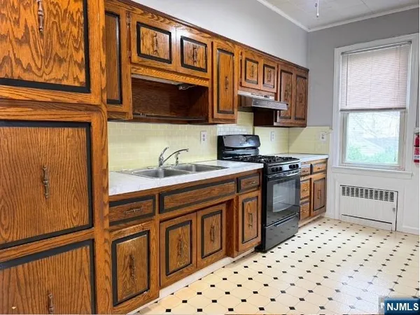 a kitchen with stainless steel appliances kitchen island granite countertop a refrigerator and a stove top oven