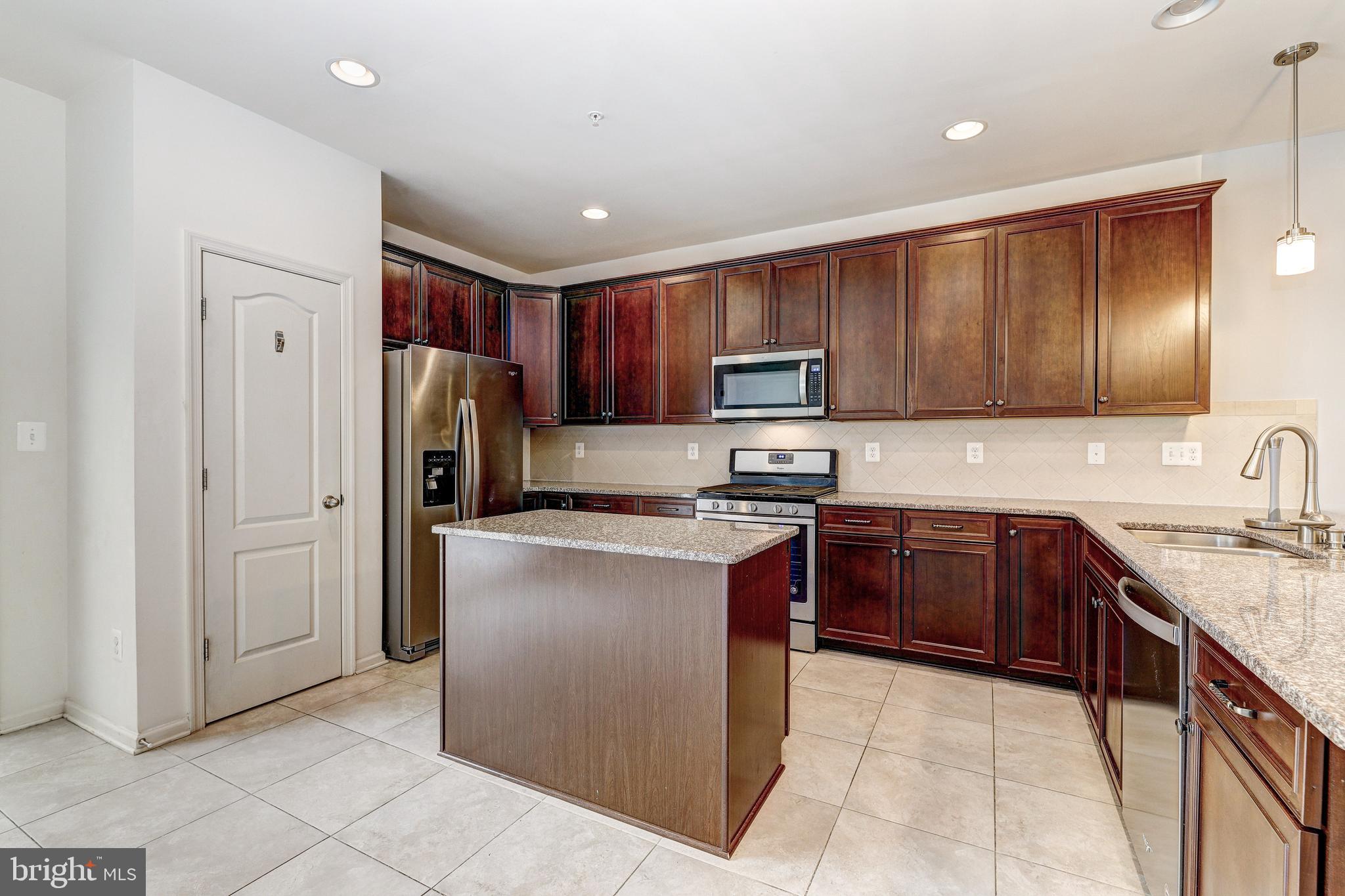 912 Winter Run Road Middle River, MD 21220 - Photo 11 of 55 a kitchen with stainless steel appliances granite countertop a refrigerator stove and sink
