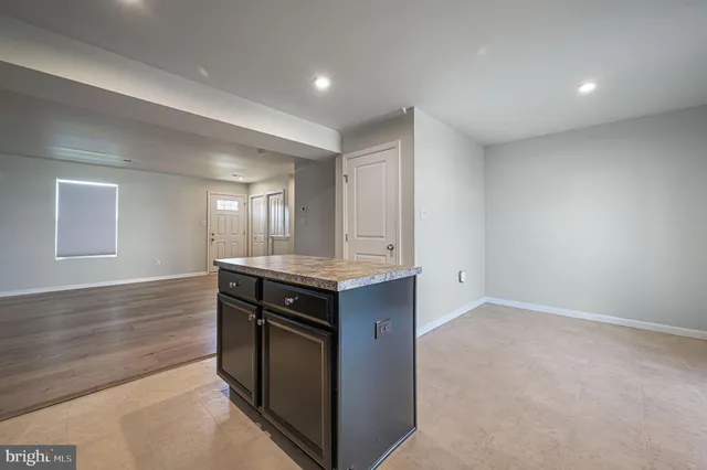 a kitchen with granite countertop a stove and a sink
