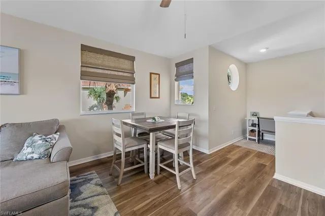 a dining room with furniture and wooden floor