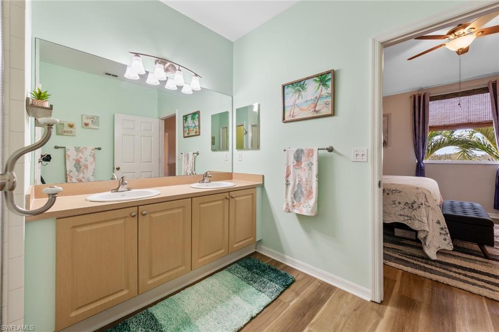 4306 Bellasol Circle, Unit 3422 Fort Myers, FL 33916 - Photo 17 of 41 Bathroom featuring light wood-style floors, double vanity, ensuite bath, and ceiling fan