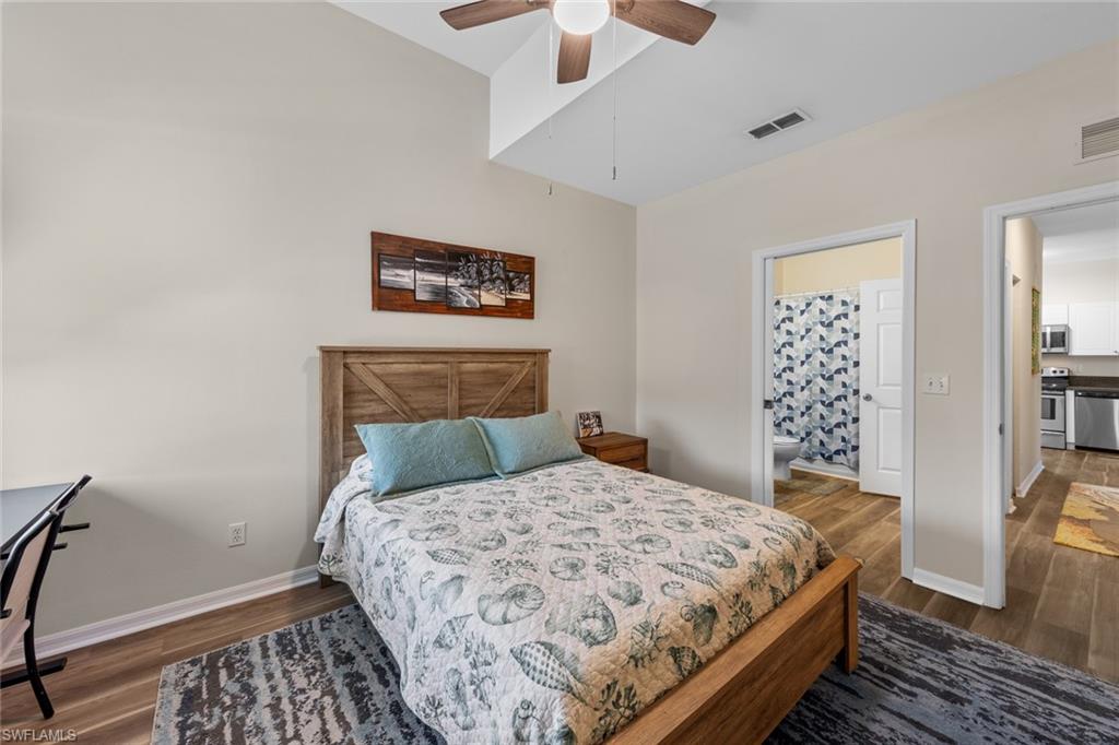 4306 Bellasol Circle, Unit 3422 Fort Myers, FL 33916 - Photo 22 of 41 Bedroom featuring dark wood-style flooring, ensuite bath, and ceiling fan