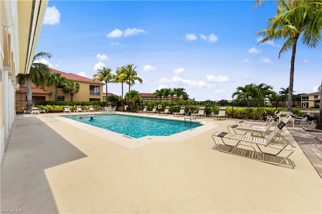 4306 Bellasol Circle, Unit 3422 Fort Myers, FL 33916 - Photo 34 of 41 Community pool with a patio area