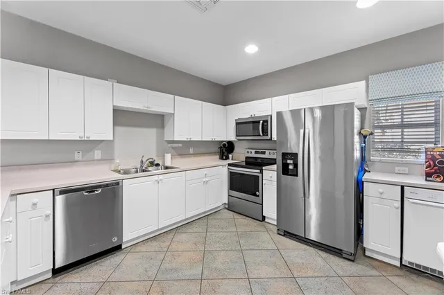 a kitchen with cabinets and stainless steel appliances