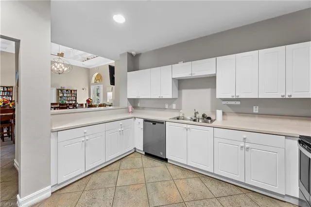 a kitchen with white cabinets appliances and a sink