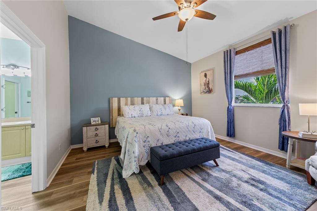 4306 Bellasol Circle, Unit 3422 Fort Myers, FL 33916 - Photo 4 of 41 Bedroom with wood finished floors, vaulted ceiling, a ceiling fan, and ensuite bathroom