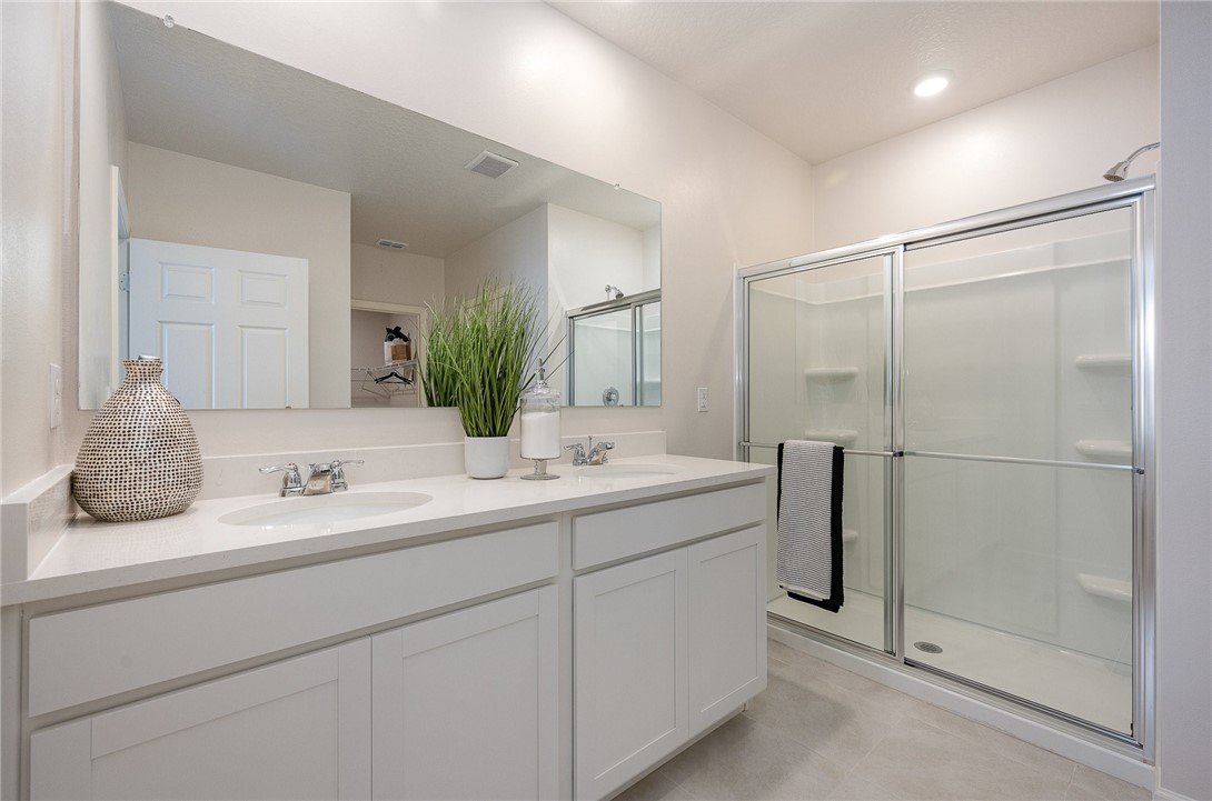 929 Devon Avenue Sebastian, FL 32958 - Photo 22 of 33 a bathroom with a double vanity sink mirror and shower