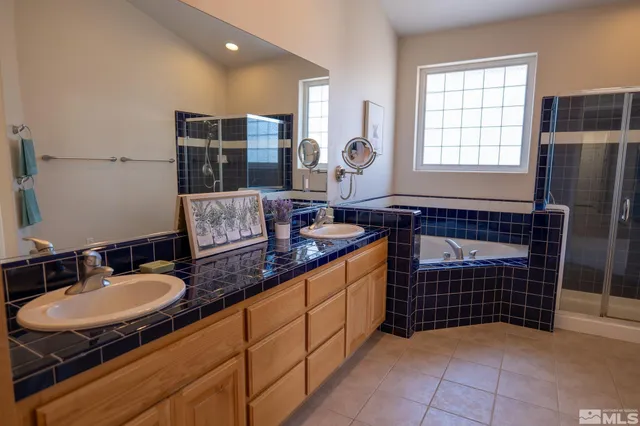 a bathroom with double vanity and a mirror