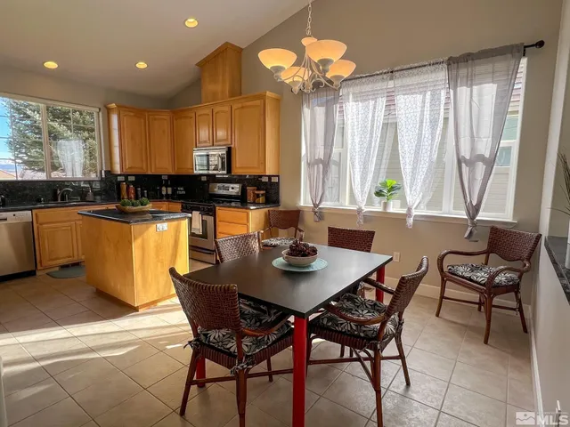 a view of a dining room with furniture window and outside view