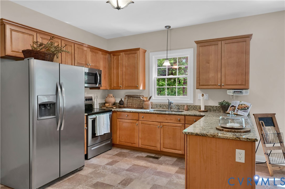 16148 Buckfast Place Beaverdam, VA 23015 - Photo 9 of 48 a kitchen with stainless steel appliances granite countertop a refrigerator stove and sink
