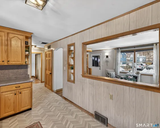 a bathroom with a toilet a sink a mirror and a window