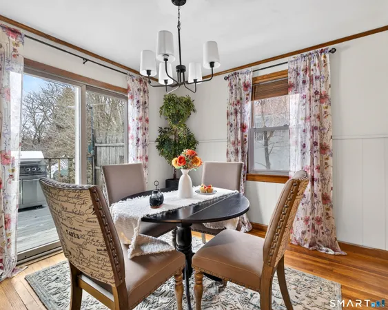 a dining room with furniture and wooden floor