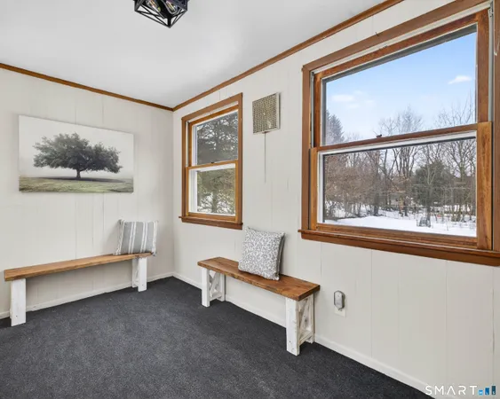 a bed sitting in a spacious bedroom next to a window