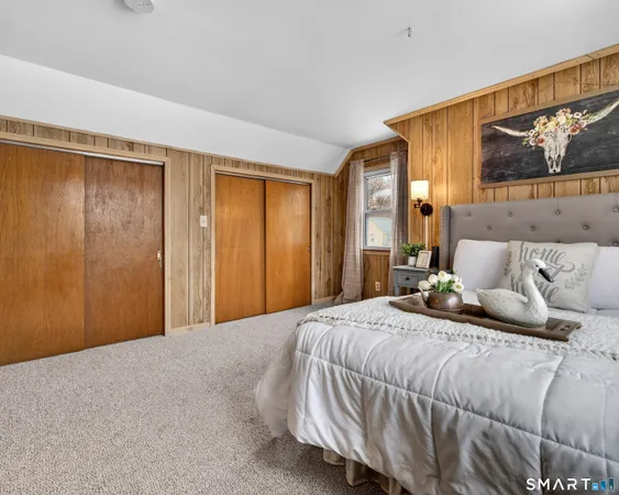 a bedroom with bed and a large window