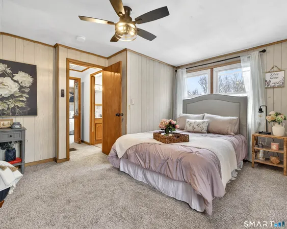 a bedroom with bed and window with outer view