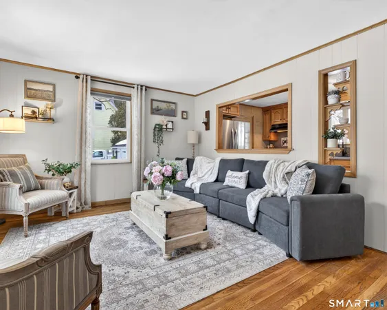 a living room with furniture and painting on the wall