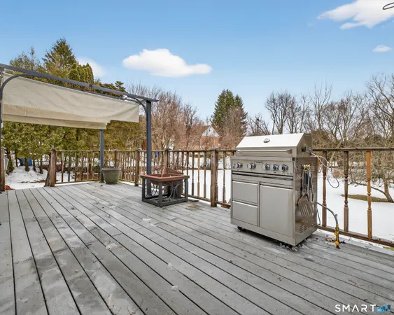 a view of a balcony with wooden floor and floor to ceiling window