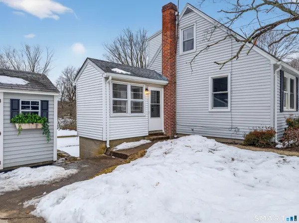 a view of a house with a snow on the road