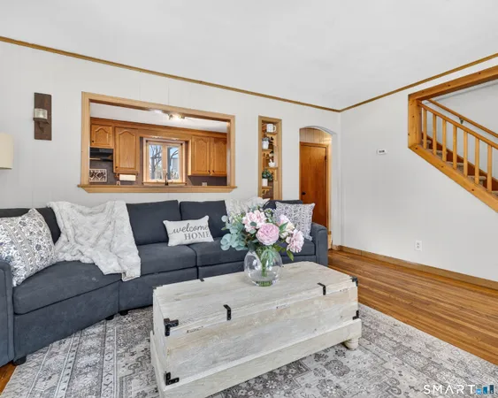a living room with furniture and flowers