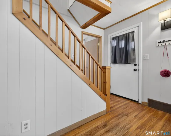a view of an entryway with wooden floor