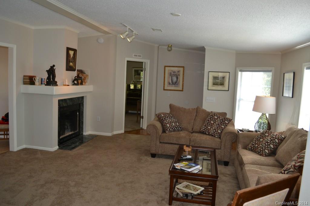 774 Sunderland Road Southwest Concord, NC 28027 - Photo 3 of 12 a living room with furniture a fireplace and a window