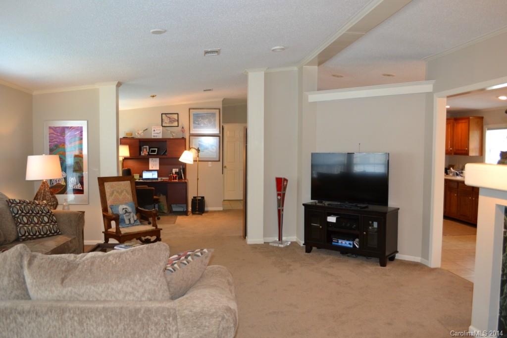 774 Sunderland Road Southwest Concord, NC 28027 - Photo 4 of 12 a view of a livingroom with workspace and a flat screen tv