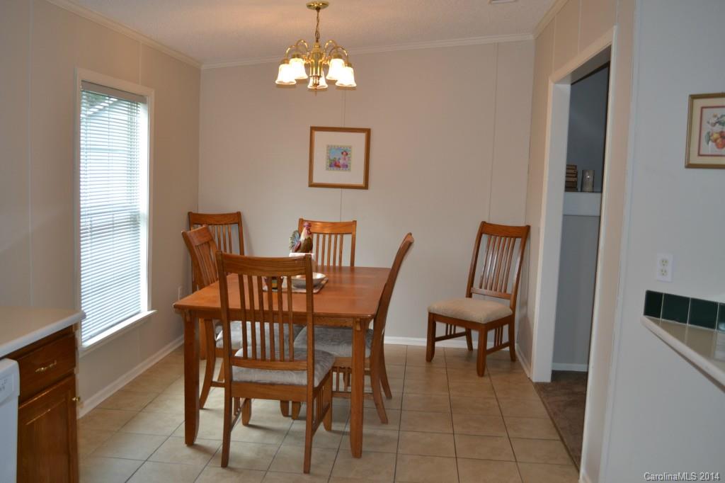 774 Sunderland Road Southwest Concord, NC 28027 - Photo 6 of 12 a view of a dining room with furniture wooden floor and chandelier
