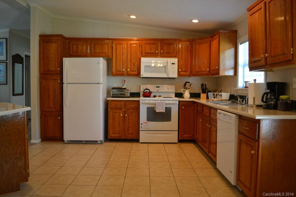 774 Sunderland Road Southwest Concord, NC 28027 - Photo 8 of 12 a kitchen with a refrigerator sink and cabinets