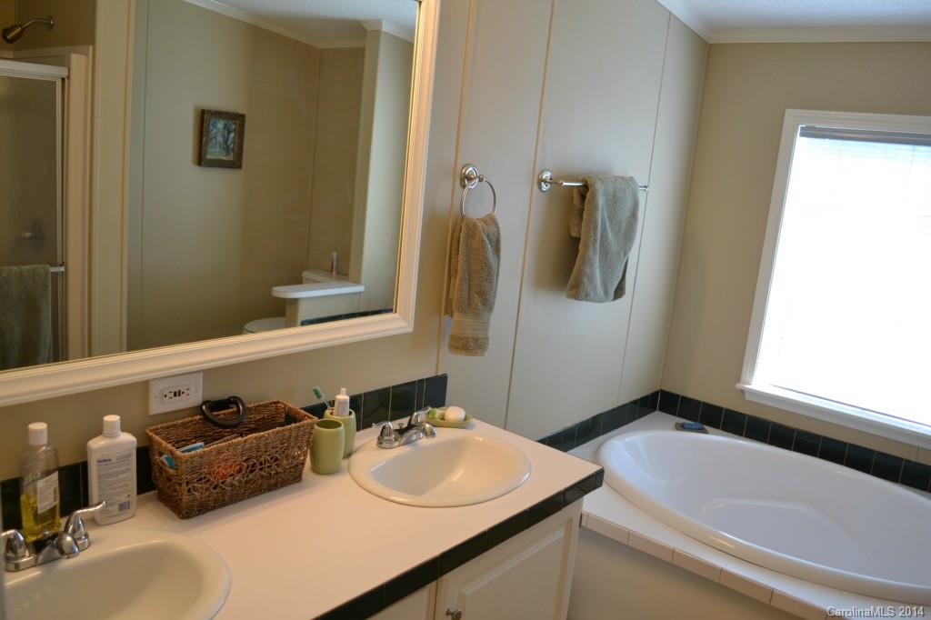 774 Sunderland Road Southwest Concord, NC 28027 - Photo 9 of 12 a bathroom with a sink and a mirror