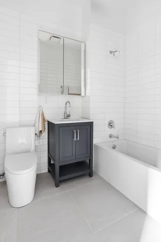 a bathroom with a toilet a sink and bathtub