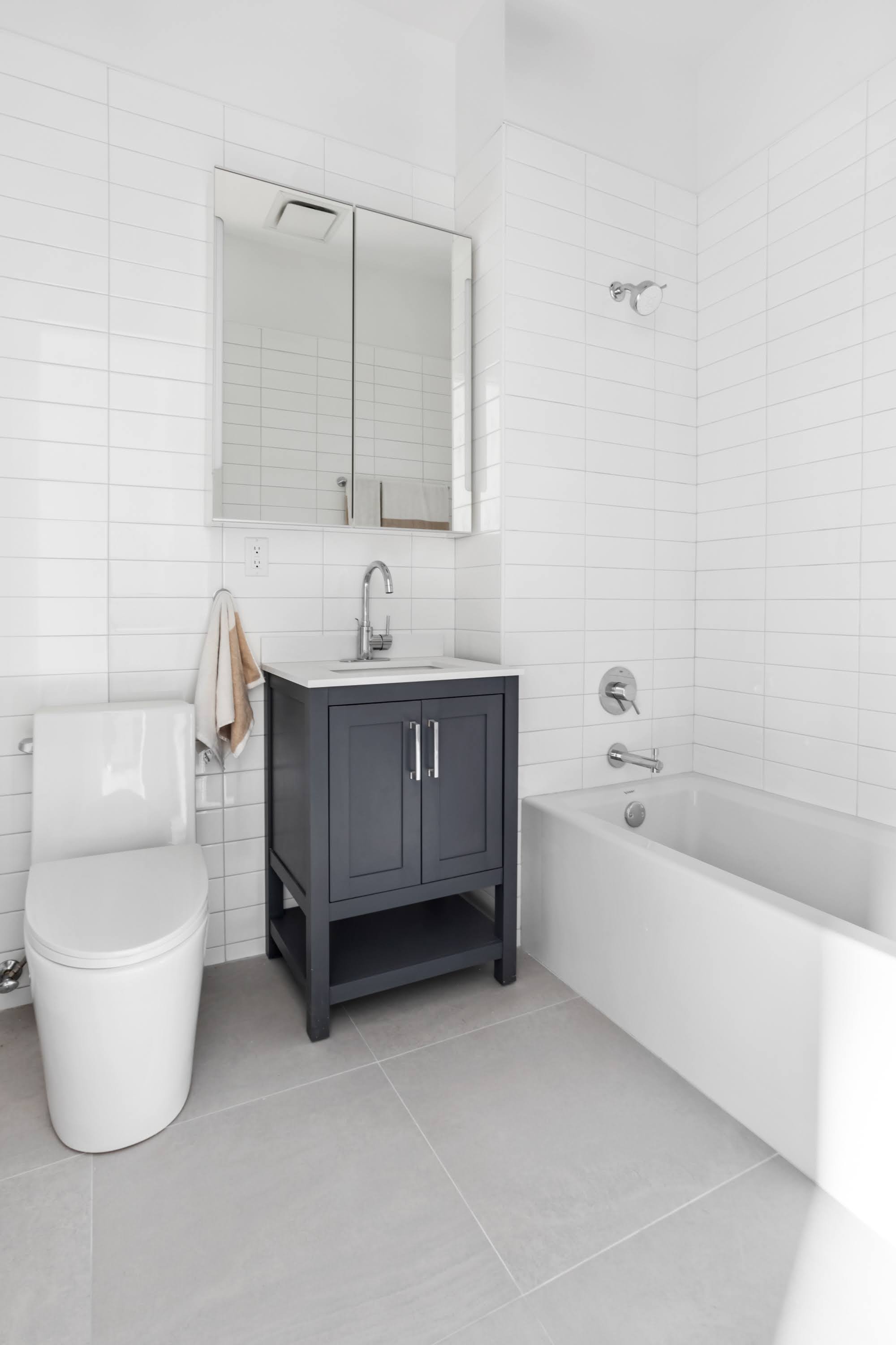 457 West 150th Street, Unit 1C Manhattan, NY 10031 - Photo 3 of 4 a bathroom with a toilet a sink and bathtub